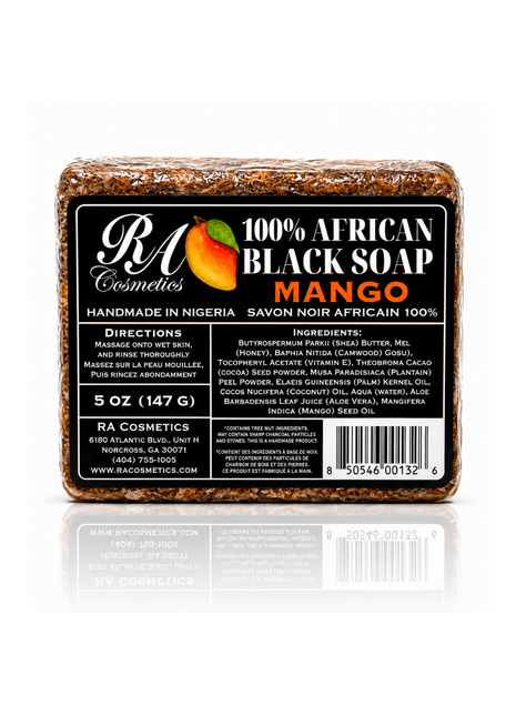 A rectangular bar of RA Cosmetics 100% African Black Soap in Mango scent, featuring a black label with white and orange text and a mango graphic, set against a white background with a reflection below.