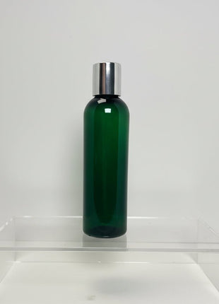 Green bottle with silver cap on a white background