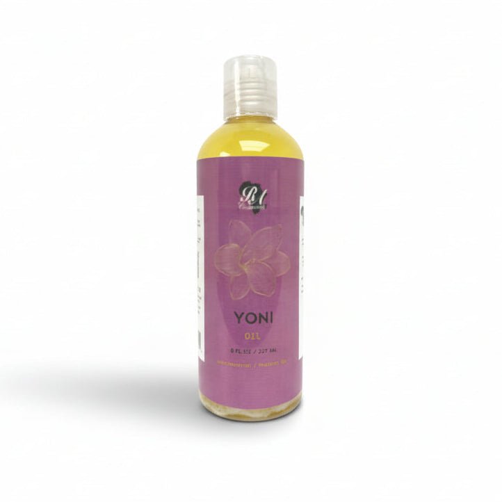 A bottle of Yoni Oil placed on a white surface, with a purple label that includes floral designs and the product name 'YONI' in bold letters.